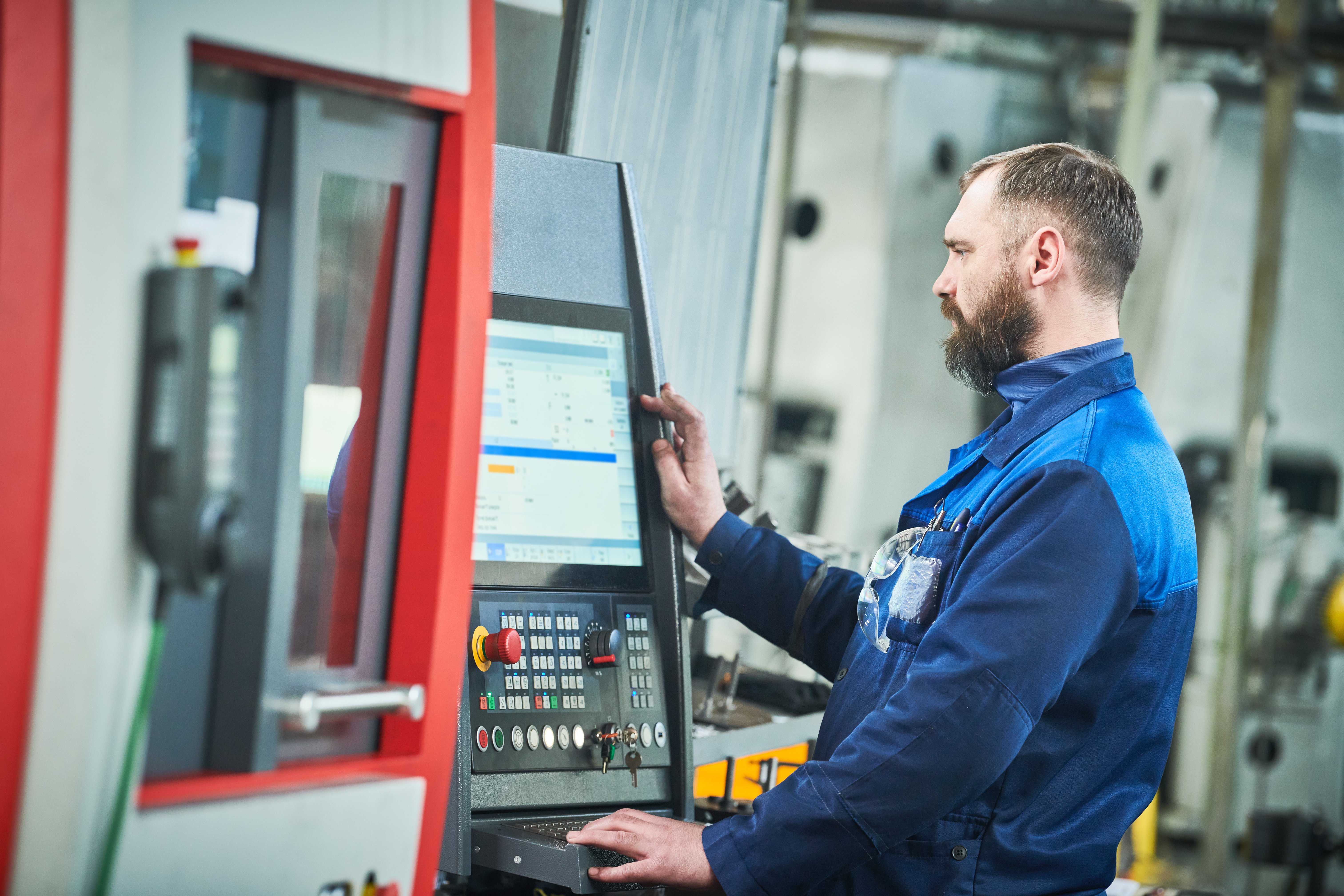 Machinist making parts on a CNC machine.